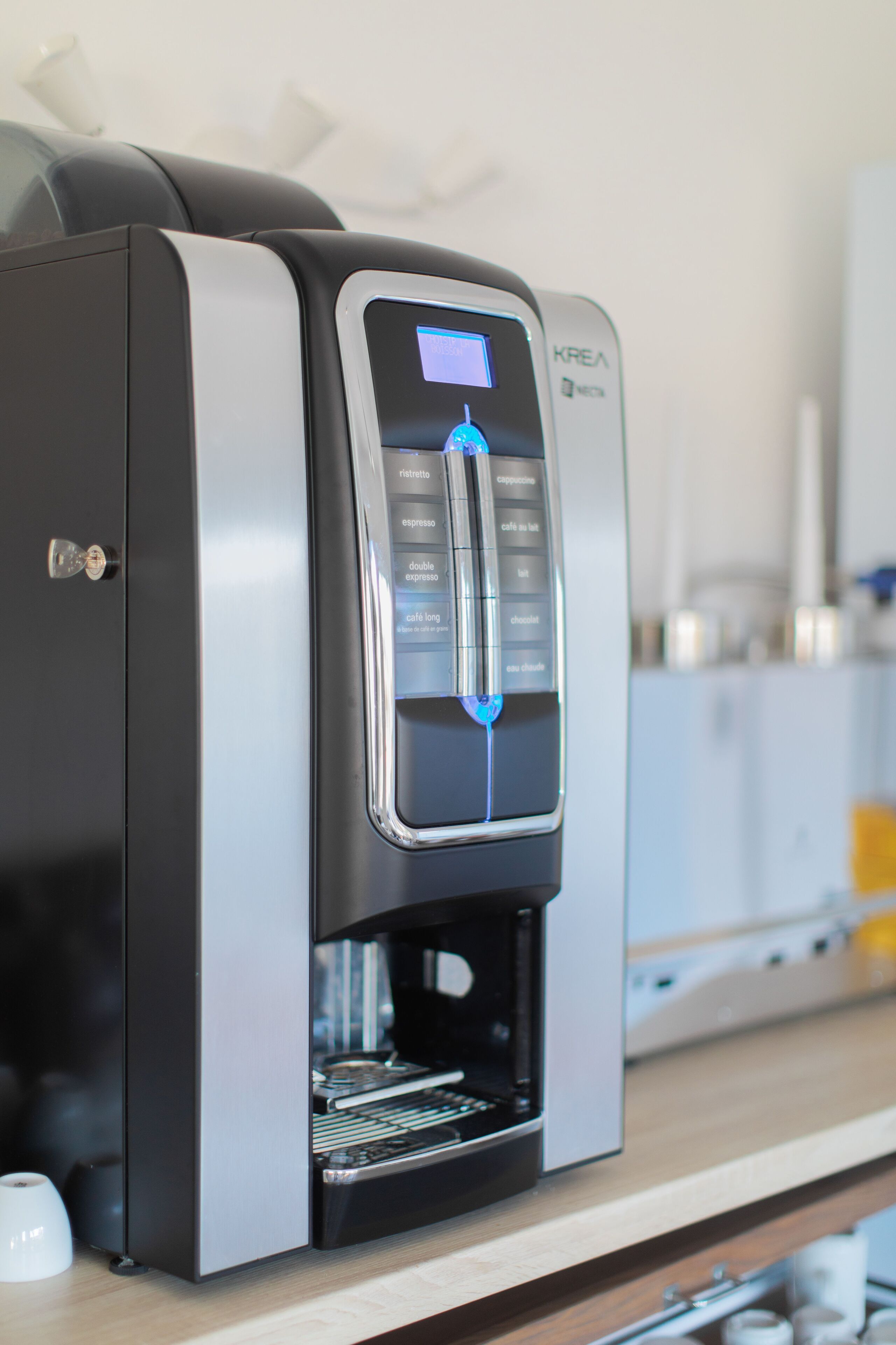 A modern coffee machine with a digital display and multiple coffee options.