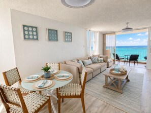A living room with a dining area, a sofa set, and a view of the ocean. - Beachfront 3 Bdrm Gem in Isla Verde Walk 2 Eat (Carolina)
