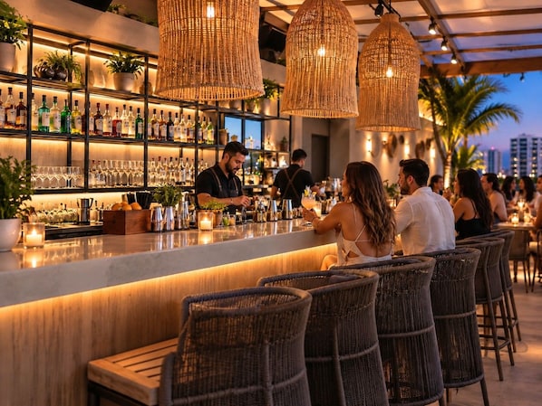 A bar area with wicker chairs, a bar counter, and shelves stocked with bottles and glasses. - Beachfront 3 Bdrm Gem in Isla Verde Walk 2 Eat (Carolina)