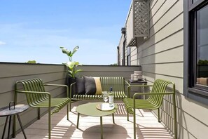 Relax on the patio with a round table and comfortable seating for two.