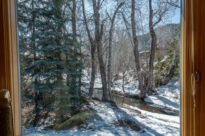 Escape to a serene winter wonderland with a tranquil forest view.