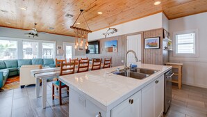 A spacious kitchen with a large island, wooden ceiling, and modern appliances. - Gorgeous, pet friendly, coastal cottage within walking distance to the restauran (Port Aransas)