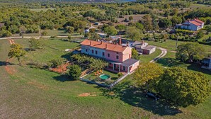A large house with a red roof, surrounded by a well-maintained lawn and a swimming pool. - Ines in Barban  - Haus für 4-5 Personen (Barban)