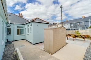Enjoy a home away from home with a patio area featuring a bench and picnic table.