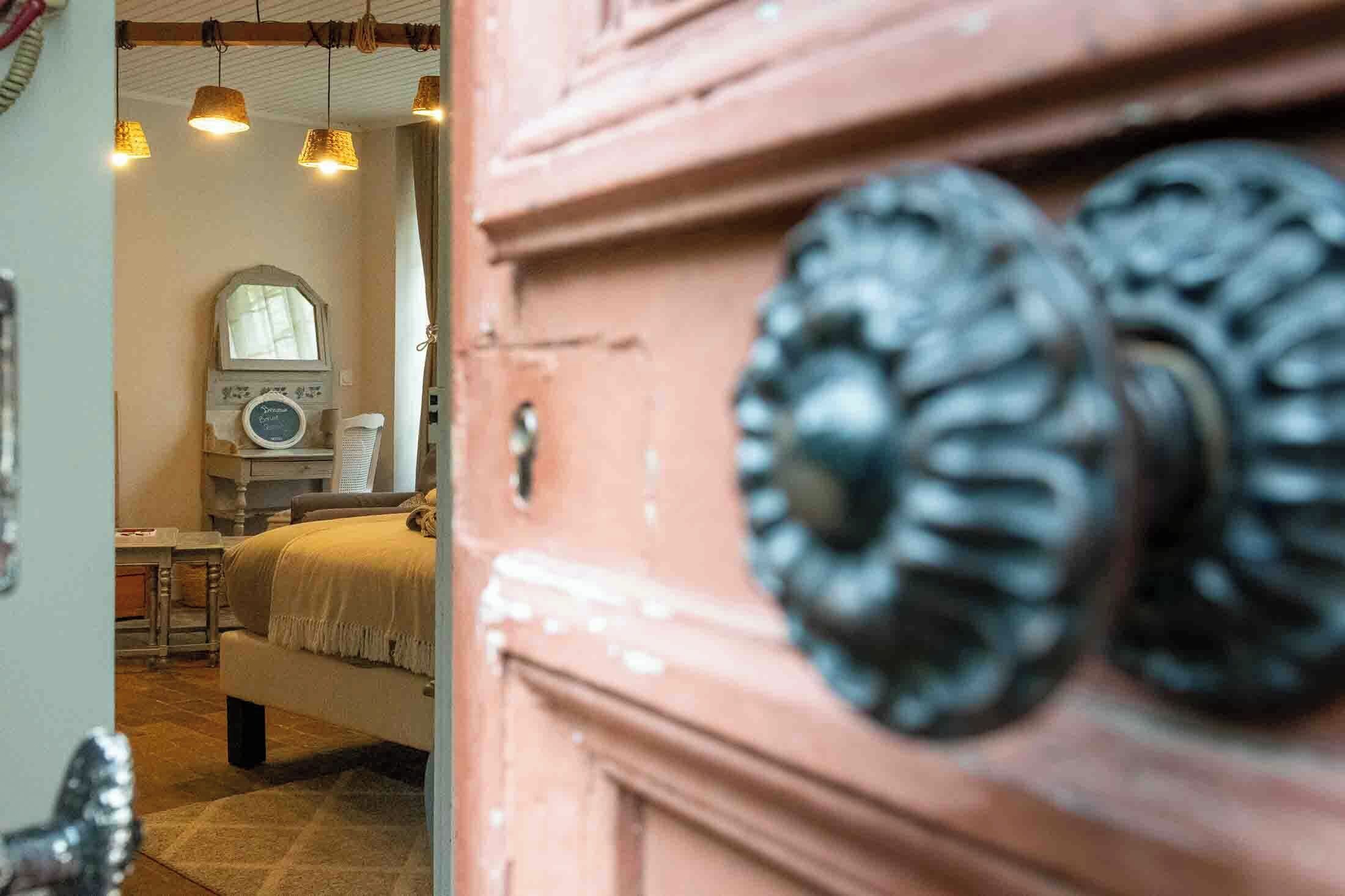 A bedroom with a bed, a dresser, and a mirror.