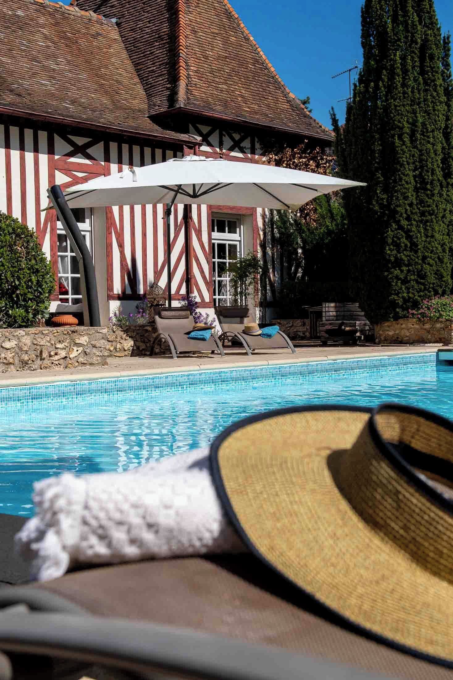 Seasonal outdoor pool, open 9:00 AM to 8:30 PM, pool umbrellas