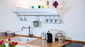 A kitchen with a sink, a coffee maker, a toaster, and a tablet on the counter. - Apartment at 500 meters from the sea (Monopoli)
