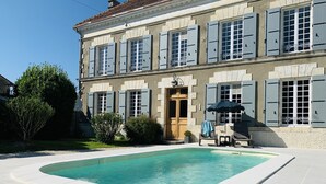A two-story building with a swimming pool in front. - Gîte des Ruches, Peaceful & Homely 1 bedroom Gîte with pool (Chives)