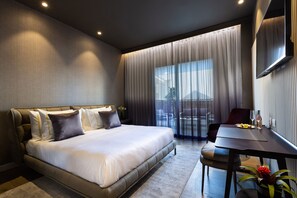 A modern hotel room with a large bed, a dining table, and a view of the outdoors. - Dhotel (Ma'ale Adumim)