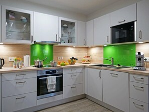 Enjoy cooking in this kitchen with a microwave, oven, and coffee maker, plus ample countertop space for food preparation.