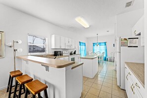 Enjoy meals in the kitchen with a central island and dining area through the window.