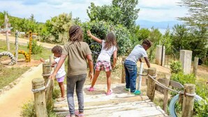 A wooden bridge with rope railings in a natural setting. - Cabin in the Farm - Peach (Nakuru)