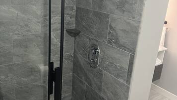 Shower, hair dryer, towels, toilet paper
