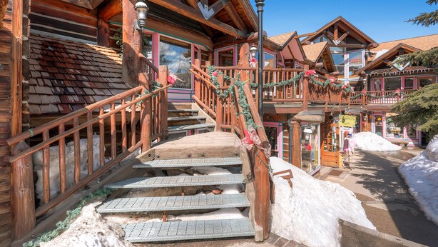 A wooden building with a staircase leading to a balcony, surrounded by snow. - Home in Downtown Breck w/ private hot tub, fireplace, and walkable to Main St (Breckenridge)