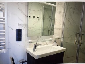 Shower, hair dryer, towels, toilet paper