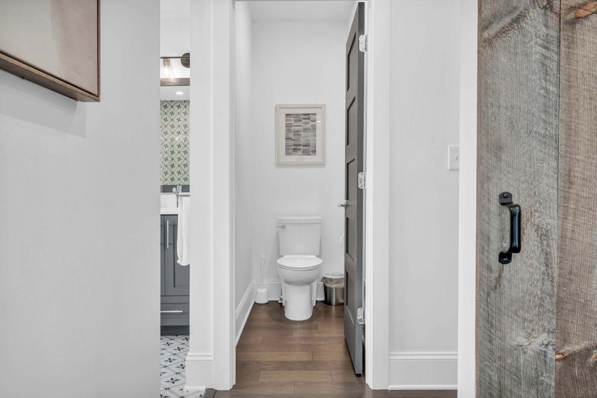 Sleek hallway and bathroom entry with clean modern finishes offering comfort and convenience throughout your stay.