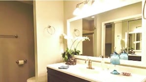 A bathroom with a sink, mirror, and toilet. - Cape Fear’s Original 1908 Cozy Historic Getaway (Wilmington)