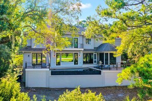 Enjoy a view of the surrounding greenery from the spacious deck with outdoor seating.