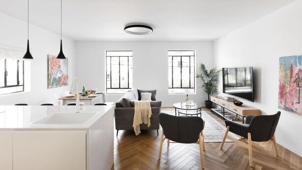 A modern living space with a kitchen, dining area, and seating area.