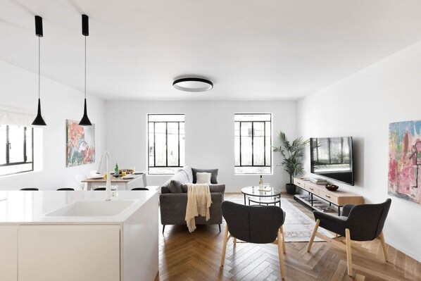 A modern living space with a kitchen, dining area, and seating area.