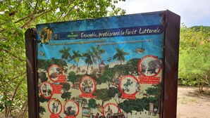 A signboard with environmental protection guidelines for the Littoral Forest.