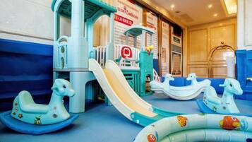 A children's play area with slides and inflatable toys.