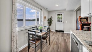 A dining area with a table, chairs, and a view of the outdoors.