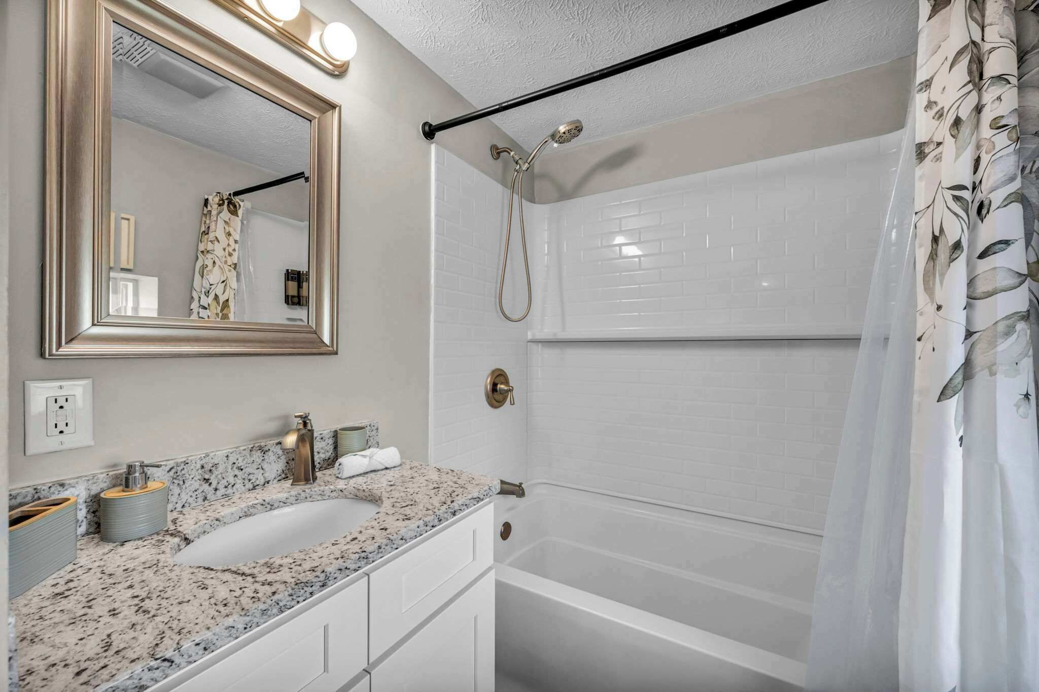 A bathroom with a double sink, a large mirror, a shower, and a bathtub.