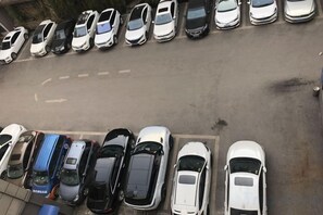 A parking lot with multiple rows of parked cars. - Huaxia Hotel (Dazhou)