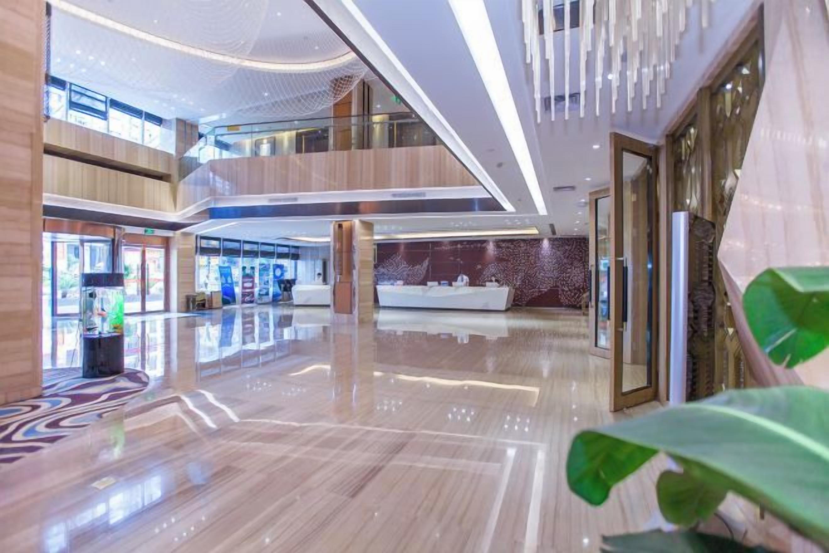 A spacious lobby with a high ceiling, multiple levels, and a modern design.