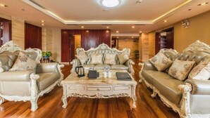 A luxurious living room with ornate furniture, a coffee table, and a modern ceiling light. - Lian Shan Longshan Garden Hotel (Lianshan)