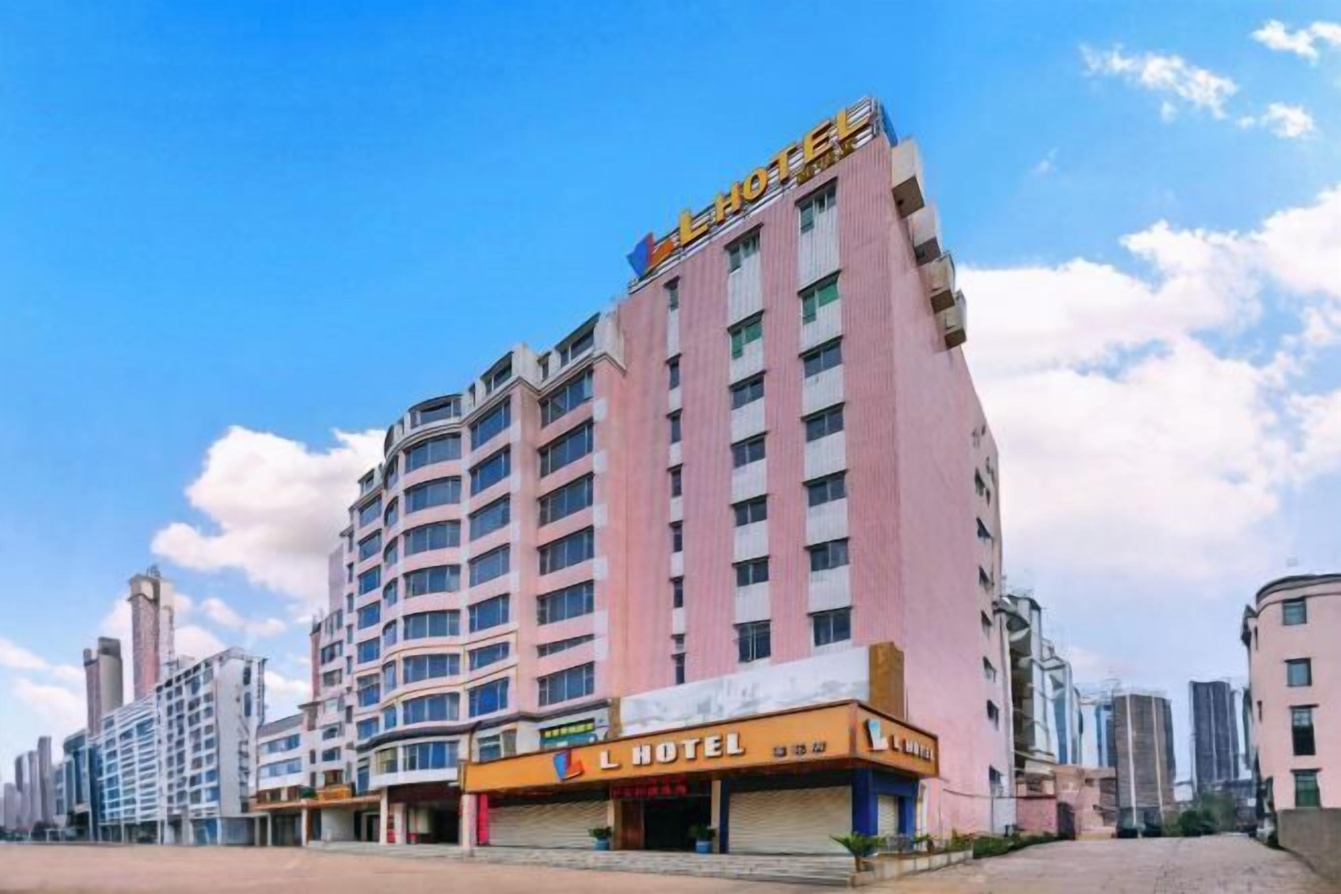 A multi-story hotel with a prominent 'L HOTEL' sign on the facade.