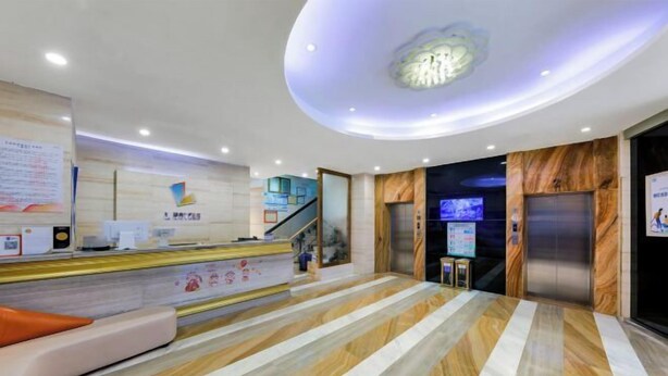 A modern hotel lobby with a reception desk, a staircase, and an elevator. - L Hotel Zhuhai Gongbei Port Qinglv Road (Zhuhai)
