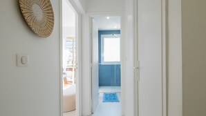 A hallway leading to a balcony with a view of the sea. - Stylish 2-Br Apartment Steps from the Croisette (Cannes)
