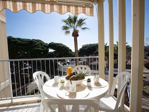 Enjoy a quiet moment on the balcony with a cup of coffee, surrounded by lush greenery.