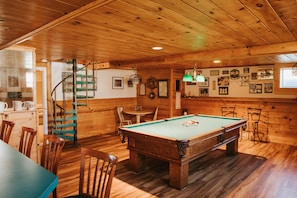 Game room with beautiful pool table and wet bar.