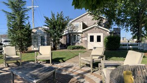 A patio area with outdoor furniture and a house in the background. - 20 minute walk to downtown and beach - Rehoboth Ave Extended (Rehoboth Beach)