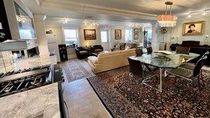 A spacious living room with a glass dining table, comfortable seating, a fireplace, and a piano. - 20 minute walk to downtown and beach - Rehoboth Ave Extended (Rehoboth Beach)
