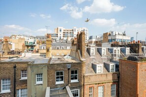 A high-rise urban area with multiple buildings, including a mix of residential and commercial structures. - Large Covent Garden 1BR, Charing Cross/Embankment station, by Blueground (London)