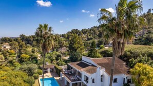 A white villa with a tiled roof, a swimming pool, and a covered patio area. - Villa Bellavista by Interhome (Jávea)