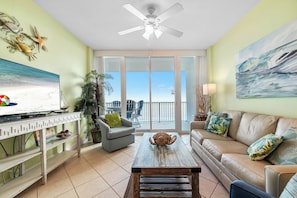 Relax in this stylish living room with a large flat-screen TV, comfortable sofa, and ocean views.
