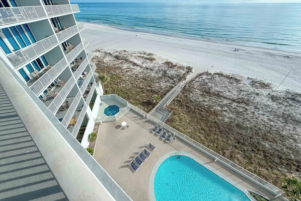 Relax by the pool or on the adjacent beach, surrounded by lush greenery and ocean views.