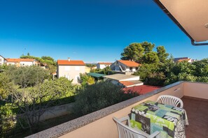 Enjoy a peaceful view of the surrounding residential area from this balcony.