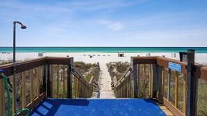 A wooden boardwalk leading to a beach with a sign indicating a gate code is required. - EXQUISITE!  GULF FRONT~5th Floor~ Specials ~ Free Beach Service! Completely Remodeled (Panama City Beach)