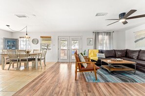 Relax in this stylish living area with a dining table, sofa, and coffee table.