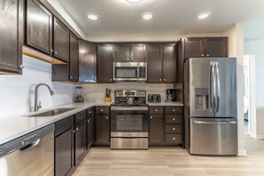 Fridge, microwave, oven, stovetop - Modern Penthouse in The Reserve at Vista Cay | Across the Street from Epic Universe | Sleeps 6 (Orlando)