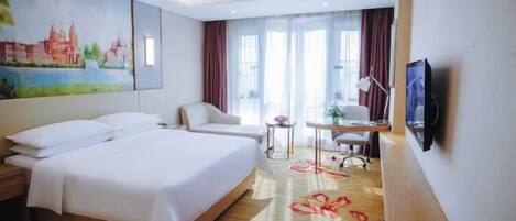 A hotel room with a large bed, a desk, a chair, a TV, and a painting on the wall.