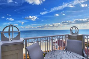 Enjoy ocean views from this outdoor seating area with two chairs and a table.