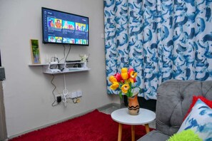 Deluxe Studio | Living area | 14-inch Smart TV with digital channels, TV - Stay.Plus Tsavo Studio Apartment (Nairobi)