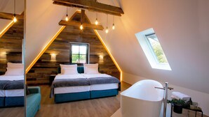 A bedroom with two beds, a skylight, a large bathtub, and wooden paneling on the walls. - Plitvice Holiday Lodge (Plitvicka Jezera)
